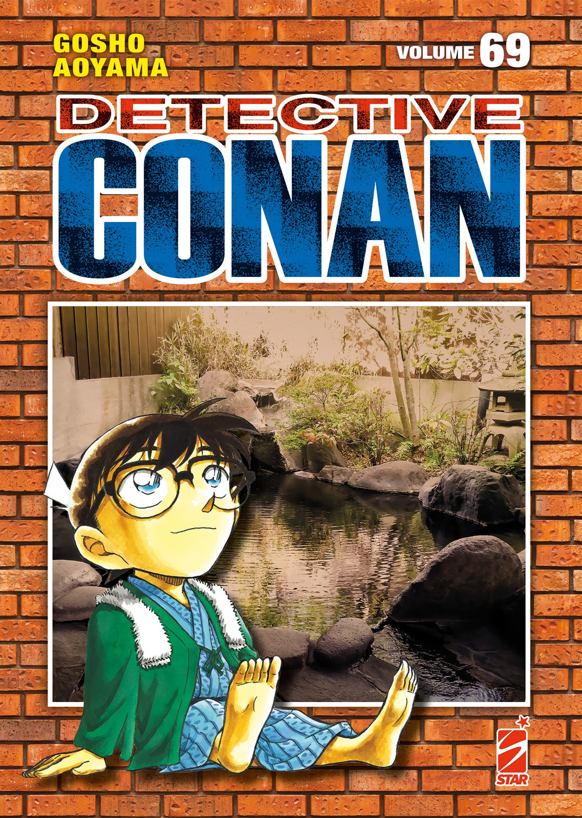 Copertina del manga Detective Conan New Edition volume 69. Il protagonista è seduto davanti a un laghetto termale su uno sfondo di mattoni arancioni.
