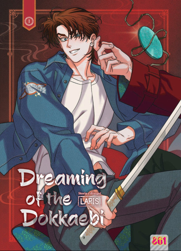 Copertina del primo volume del manhwa Boys' Love 'Dreaming of the Dokkaebi' di LAPIS, edito da Magic Press. L'illustrazione ritrae in primo piano il protagonista sorridente con capelli castani e giacca di jeans mentre impugna una spada, affiancato da un braccio in elegante abito tradizionale che sostiene un medaglione di giada, con il titolo in bianco e il logo 801 in basso a destra.