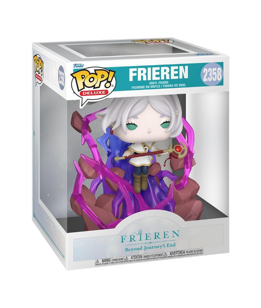 Scatola originale del Funko POP! Deluxe numero 2358 raffigurante Frieren dall'anime Frieren: Beyond Journey's End. La figure all'interno mostra la maga elfa che stringe il suo bastone, circondata da spettacolari fiammate di energia magica viola traslucida e frammenti di roccia.