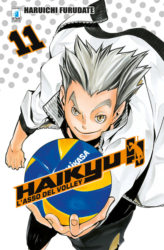 Copertina del manga Haikyu!! L'asso del volley volume 11. In primo piano un ragazzo (Bokuto) in posa dinamica, con spiccati capelli grigi a punta e un sorriso di sfida, intento a reggere un pallone da pallavolo blu e giallo. Lo sfondo è bianco a pois grigi.