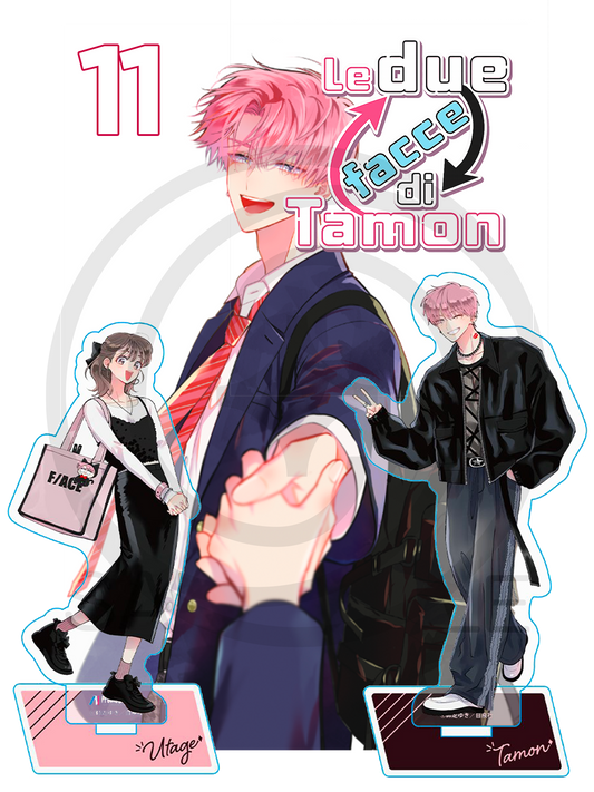 Copertina dell'undicesimo volume in edizione speciale Deluxe Variant del manga Le Due Facce di Tamon, caratterizzata dal protagonista in divisa scolastica che stringe una mano in primo piano, affiancato dai due esclusivi standini acrilici da collezione di Utage e Tamon.