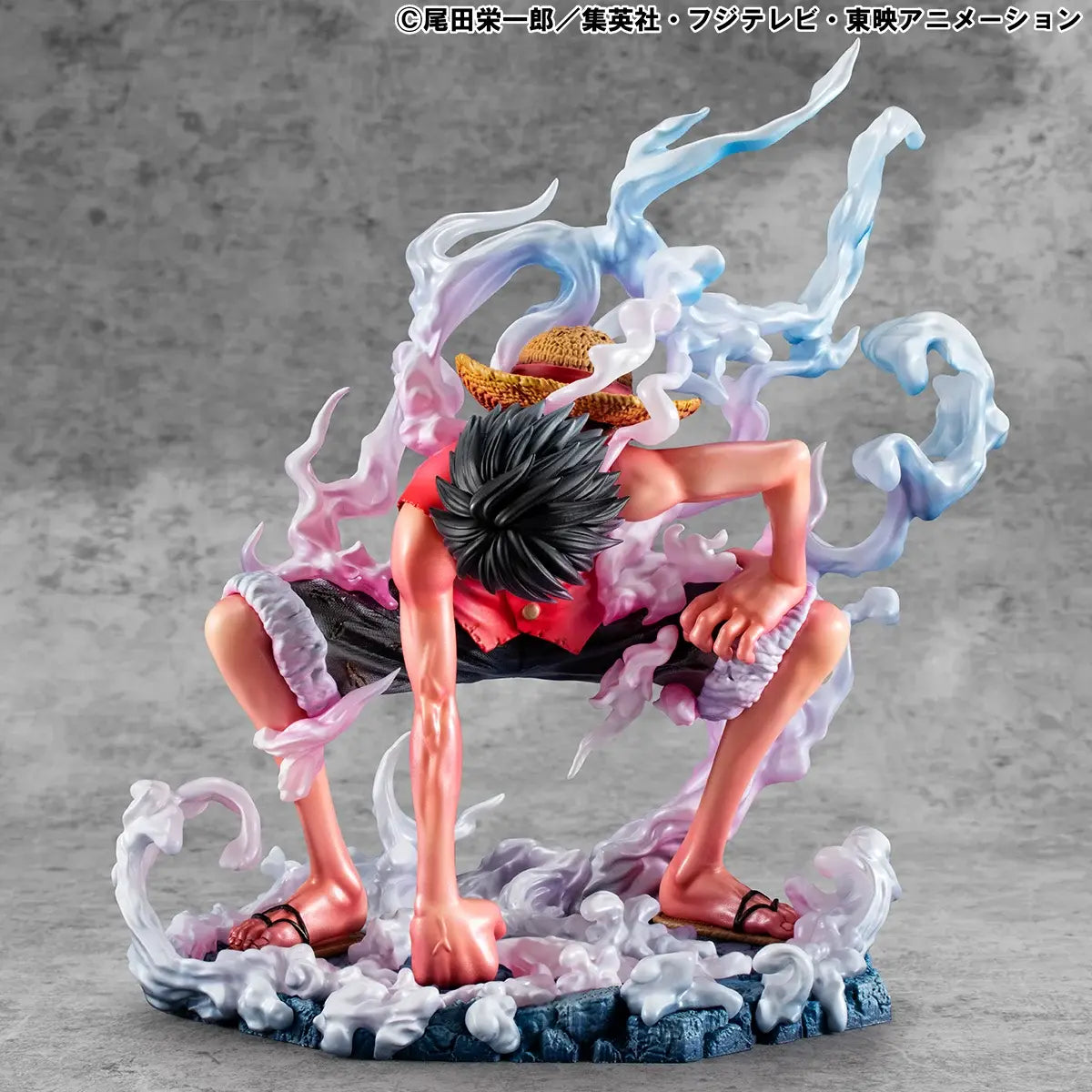 Figura da collezione di Monkey D. Luffy in modalità Gear Second tratta da One Piece, visibile nel file luffy.jpg. Il protagonista è accovacciato nella sua iconica posa da combattimento con un pugno a terra, la pelle arrossata dallo sforzo e grandi volute di fumo sfumate tra il rosa e l'azzurro che lo circondano.