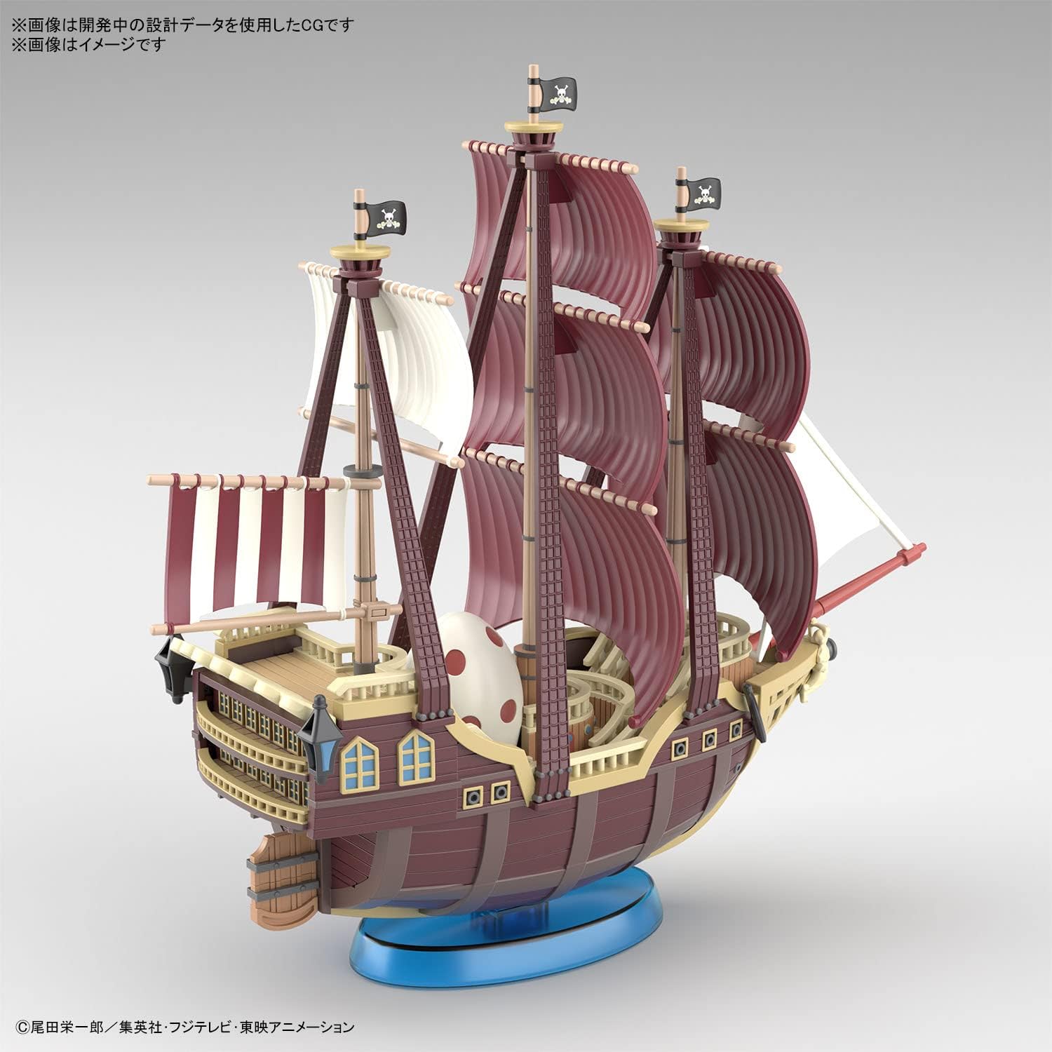 Il model kit assemblato della Oro Jackson, con le imponenti vele bordeaux a righe e la scritta "GOL D. ROGER", mentre naviga su una base effetto mare blu trasparente.