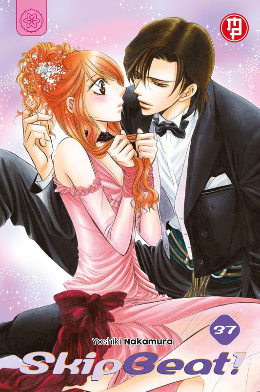 Copertina del trentasettesimo volume del manga 'Skip Beat!' di Yoshiki Nakamura, edito da Magic Press. L'illustrazione ritrae Ren Tsuruga in tuxedo vicino a Kyoko in abito da sera rosa, con il numero 37 in basso.