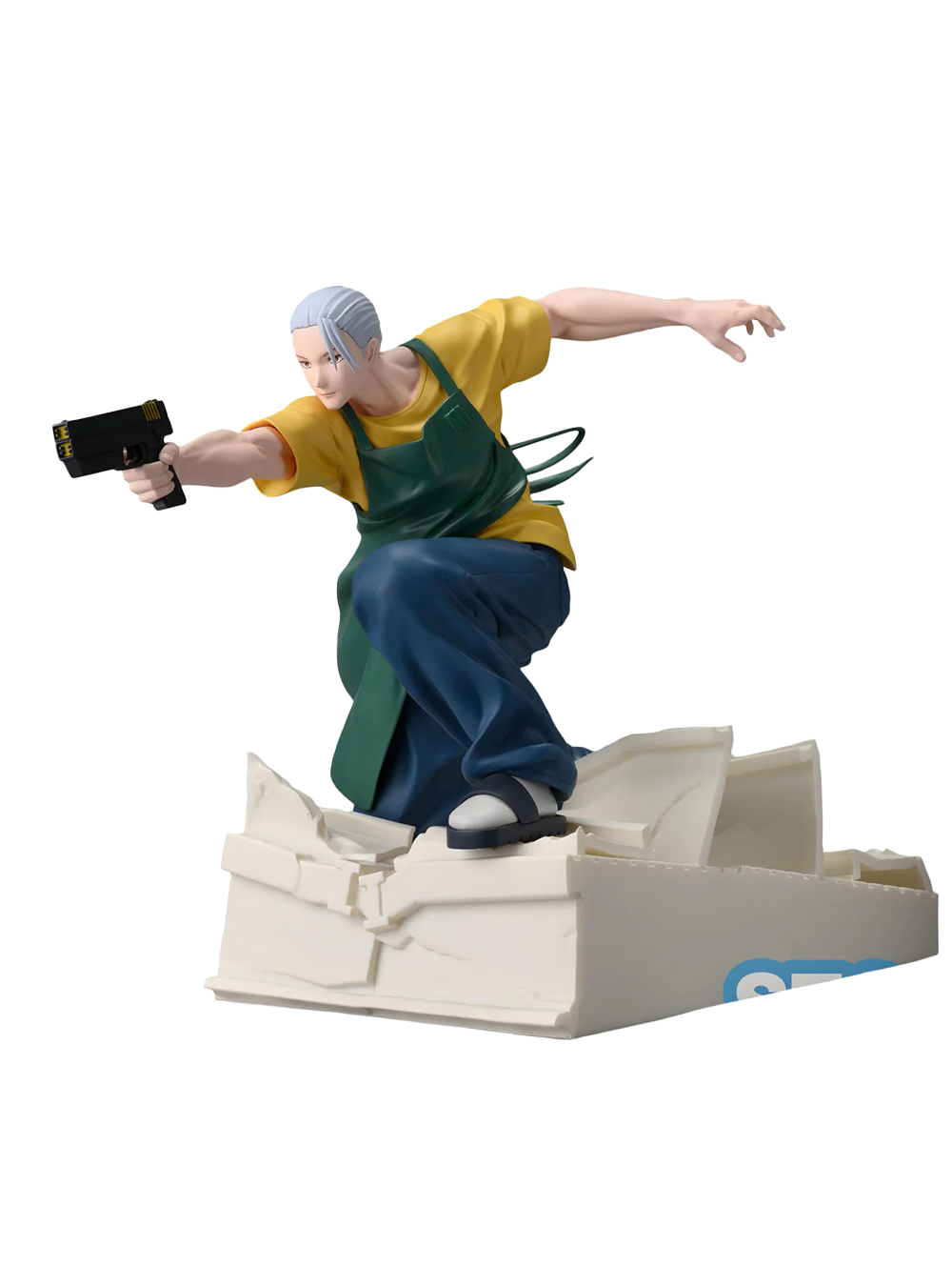 Figura da collezione di Taro Sakamoto nella sua forma magra da combattimento, tratta dal manga Sakamoto Days. Il personaggio indossa un grembiule verde sopra una maglietta gialla e pantaloni blu, mentre punta una pistola nera scivolando su macerie bianche.