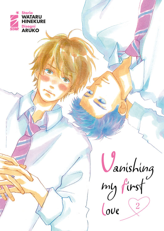 Copertina del secondo volume del manga 'Vanishing My First Love' di Wataru Hinekure e Aruko, edito da Star Comics. L'illustrazione ad acquerello ritrae Aoki dai capelli biondi e Ida dai capelli scuri sdraiati testa a testa in senso opposto con addosso la camicia scolastica, sormontati dal titolo in corsivo e dal numero 2 racchiuso in un cuoricino rosa in basso a destra.