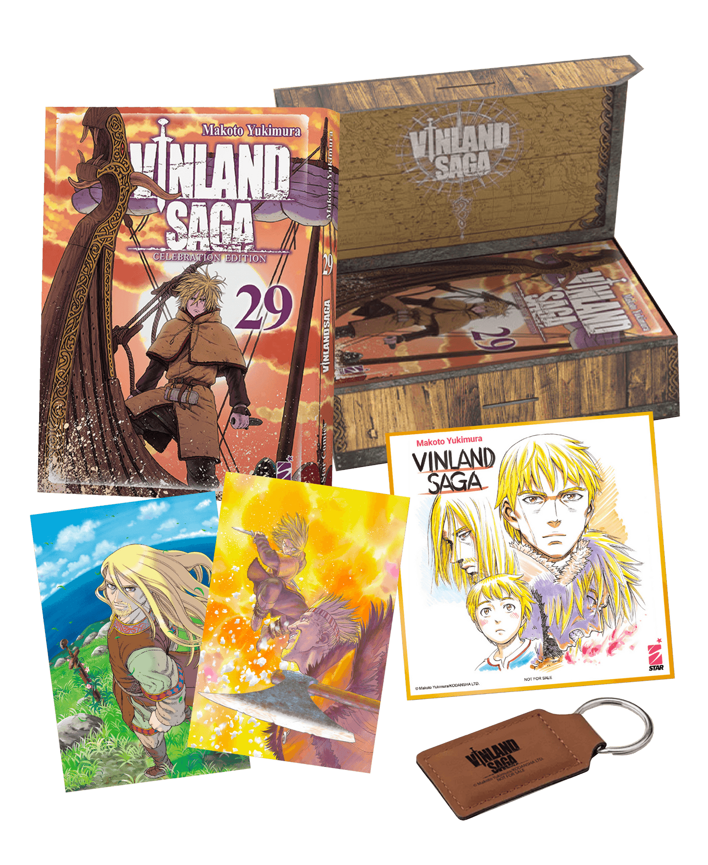 Cofanetto Celebration Edition di Vinland Saga Vol. 29 aperto; il box effetto legno è circondato dai contenuti: il volume 29 con Thorfinn in copertina, un portachiavi in ecopelle marrone, uno shikishi con tre volti e due litografie a colori.