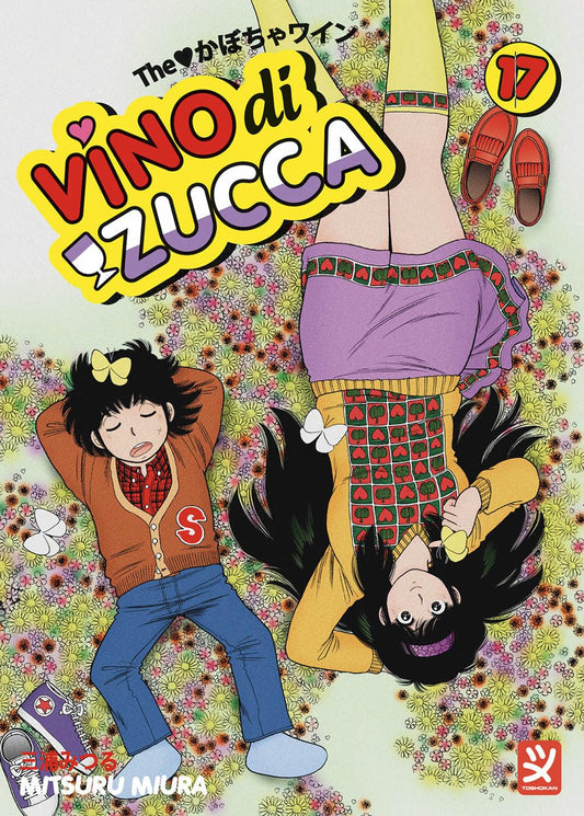 Copertina del diciassettesimo volume del manga Vino Di Zucca. L'illustrazione, vista dall'alto, mostra i protagonisti Shunsuke ed Elle sdraiati in direzioni opposte su un prato fitto di piccoli fiori colorati. In alto a sinistra compare il titolo dell'opera in grandi lettere gialle e viola, mentre in alto a destra spicca il numero 17 all'interno di un bollino giallo.
